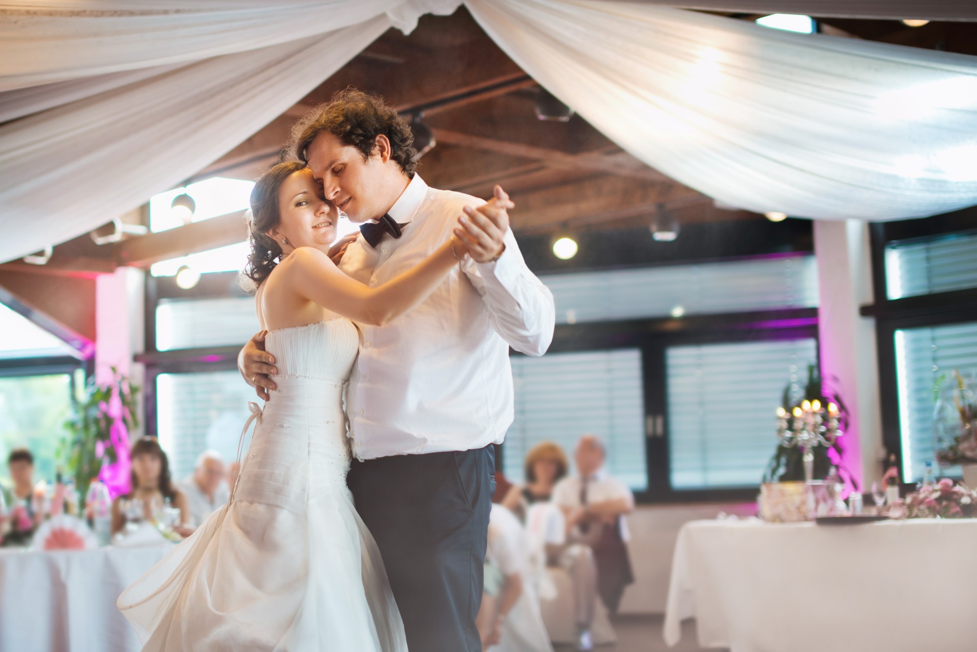 Happy just married young couple at the first wedding dance