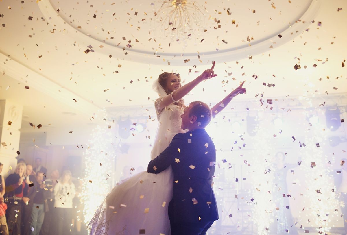 Happy beautiful newlyweds dancing in the restaurant